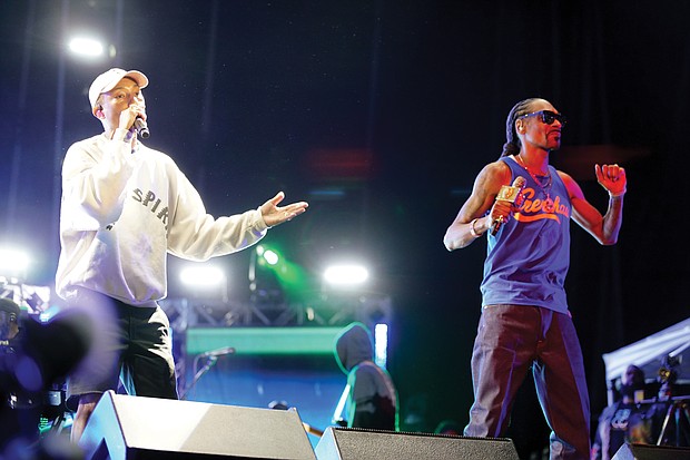 “Something in the Water” is the brainchild of Virginia Beach native Pharrell Williams, left, who performed Saturday under the banner “Pharrell & Friends.” Here, he is joined on stage by Snoop Dogg.