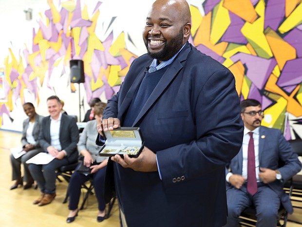 Award-winning teacher Rodney A. Robinson shows off the key to the City of Richmond presented to him by Mayor Levar M. Stoney during a ceremony last Thursday at the Virgie Binford Education Center inside the Richmond Juvenile Detention Center, where he teaches.