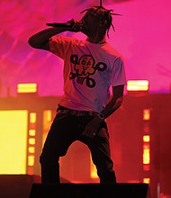 Performer Travis Scott plays to the  audience.