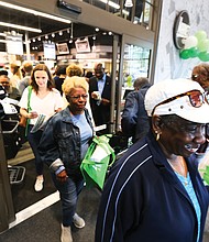 Grand opening: Shoppers flood into The Market @ 25th, the new grocery store in the East End that opened with a ribbon-cutting and big ceremony Monday at 25th Street and Fairmount Avenue. The Armstrong High School Wildcat Marching Band led the parade, with shoppers enjoying many of the locally grown and produced items inside. (Regina H. Boone/Richmond Free Press)