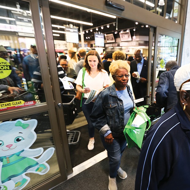 Grand opening: Shoppers flood into The Market @ 25th, the new grocery store in the East End that opened with a ribbon-cutting and big ceremony Monday at 25th Street and Fairmount Avenue. The Armstrong High School Wildcat Marching Band led the parade, with shoppers enjoying many of the locally grown and produced items inside. (Regina H. Boone/Richmond Free Press)
