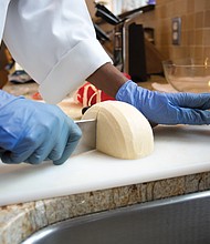 Sister Myriam Saint-Vilus unwraps and cuts a wheel of gouda in the monastery’s kitchen for a spaghetti dinner. The nuns use the cheese for almost every meal; it never goes to waste. “How can you get sick of something that you are proud of? We know how it is made and what is in it,” Sister Saint-Vilus said.