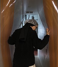 Sister Maria Gonzalo opens the curtains to the milk room at the cheese barn.
