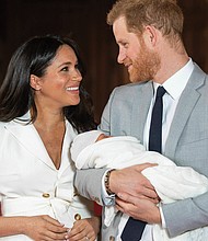 Prince Harry and Meghan Markle present their new son to the world on Wednesday during a brief photo session in St. George Hall at Windsor Castle, where their wedding reception was held last May. Master Archie was born at 5:26 a.m. Monday, weighing 7 pounds, 3 ounces.