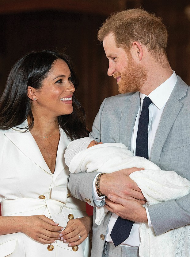Prince Harry and Meghan Markle present their new son to the world on Wednesday during a brief photo session in St. George Hall at Windsor Castle, where their wedding reception was held last May. Master Archie was born at 5:26 a.m. Monday, weighing 7 pounds, 3 ounces.