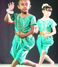 Celebrating Asian-American culture: Gianna Sa, 7, of Chesterfield County, performs a traditional Cambodian dance with members of the Cambodian Dance Troupe of the Khmer Samacky Monastery in Henrico last Saturday during the 22nd Annual Asian American Celebration. (Regina H. Boone/Richmond Free Press)