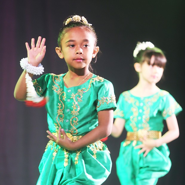 Celebrating Asian-American culture: Gianna Sa, 7, of Chesterfield County, performs a traditional Cambodian dance with members of the Cambodian Dance Troupe of the Khmer Samacky Monastery in Henrico last Saturday during the 22nd Annual Asian American Celebration. (Regina H. Boone/Richmond Free Press)