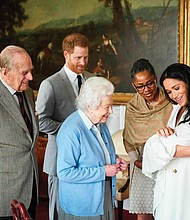 A royal arrival for Mother’s Day: New mother Meghan Markle, the Duchess of Sussex, holds her son, Archie Harrison Mountbatten-Windsor, as he is admired Wednesday by his grandmother, Doria Ragland, and great-grandmother, Queen Elizabeth II. Smiling from the side are the baby’s great-grandfather, Prince Philip, and new father, Prince Harry. The baby, born Monday to Prince Harry and Ms. Markle, is the first grandchild for Ms. Ragland and the eighth great-grandchild for the 93-year-old British monarch and the Duke of Edinburgh. (Chris Allerton©SussexRoyal)