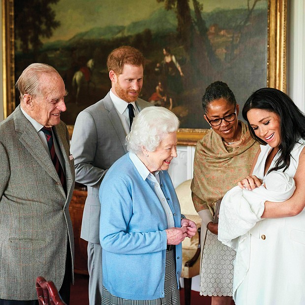 A royal arrival for Mother’s Day: New mother Meghan Markle, the Duchess of Sussex, holds her son, Archie Harrison Mountbatten-Windsor, as he is admired Wednesday by his grandmother, Doria Ragland, and great-grandmother, Queen Elizabeth II. Smiling from the side are the baby’s great-grandfather, Prince Philip, and new father, Prince Harry. The baby, born Monday to Prince Harry and Ms. Markle, is the first grandchild for Ms. Ragland and the eighth great-grandchild for the 93-year-old British monarch and the Duke of Edinburgh. (Chris Allerton©SussexRoyal)