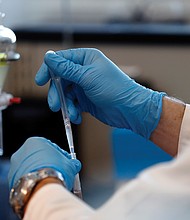 In this December 2018 photo, forensic scientist group supervisor Arthur Christy tests evidence for the presence of controlled substances at the Virginia Department of Forensic Science’s Eastern Laboratory in Norfolk.