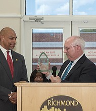 Oliver Hill Day/Lamont K. Barnes, left, program coordinator with the Richmond Department of Justice Services, receives the Unsung Hero Award from attorney James M. Nachman during the 22nd Annual Oliver Hill Day on May 10 at the Oliver Hill Courts Building. The theme: “Free Speech, Free Press, Free Society.” The event honors the memory of Mr. Hill, a lawyer and civil rights icon whose successful legal battles against racial discrimination helped end the unconstitutional doctrine of “separate but equal.” (Regina H. Boone/Richmond Free Press)