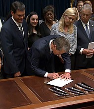 Georgia Gov. Brian Kemp signs the anti-abortion legislation Tuesday at the state Capitol in Atlanta. Executive producers for a new television show have decided not to scout for filming locations in Georgia because of the signing of the controversial "heartbeat bill."