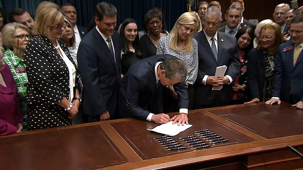 Georgia Gov. Brian Kemp signs the anti-abortion legislation Tuesday at the state Capitol in Atlanta. Executive producers for a new television show have decided not to scout for filming locations in Georgia because of the signing of the controversial "heartbeat bill."