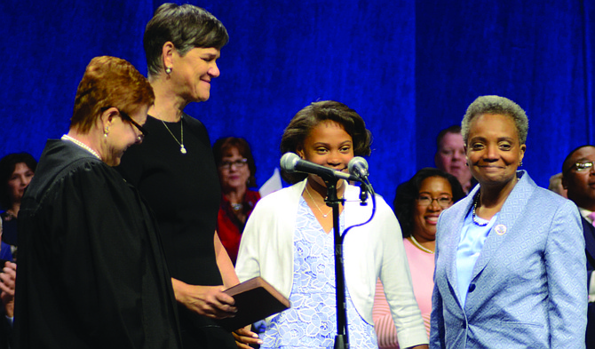 Lori Lightfoot (far right), her daughter Vivian, and wife Amy Eshleman (second from left) held hands as Lightfoot prepared to be sworn in as the 56th Mayor of Chicago. Photo Credit: Jerome Simmons