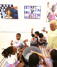 Bookworms and history buffs/
Richmond School Board member and former principal Cheryl L. Burke leads an activity about acts of kindness Monday for second-graders from G.H. Reid Elementary School during the Black History Museum & Cultural Center of Virginia’s Children’s Book Festival. The event included the reading of “Each Kindness,” a book by Jacqueline Woodson, tours of the museum’s galleries and other activities. Each student was sent home with a bag of books at the end of the day. (Regina H. Boone/Richmond Free Press)