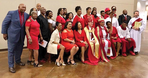 Bishop Phoebe Roaf, holding the crosier, pauses for a photo with a contingent from St. Philip’s Episcopal Church in Richmond following her consecration May 4 as bishop of West Tennessee. Seated next to Bishop Roaf is retired Bishop Shannon Johnston of the Diocese of Virginia.  (photo courtesy of St. Phillip's Episcopal Church)