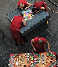 Mandala: Sacred art/Tibetan Buddhist monks from the Drepung Loseling Monastery in India create a sand mandala at the Virginia Museum of Fine Arts recently to share Tibet’s sacred visual and performing arts with area audiences. The monks’ work, created over four days, was completed in conjunction with the VMFA’s new exhibit, “Awaken: A Tibetan Buddhist Journey Toward Enlightenment,” that features roughly 100 historical and contemporary objects highlighting the role of art in Tibetan Buddhist culture and religious practices. (Sandra Sellars/Richmond Free Press)