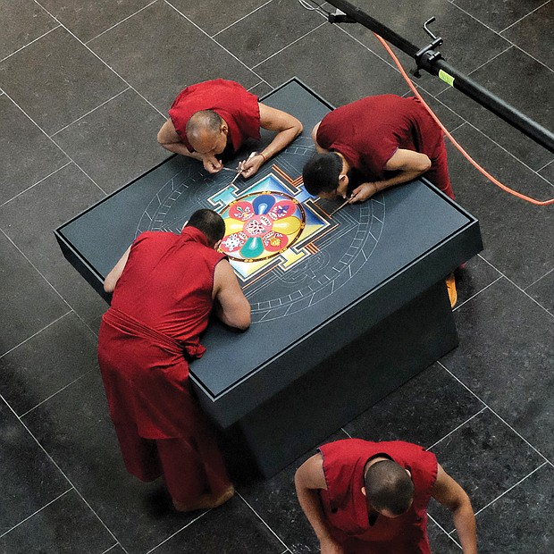 Mandala: Sacred art/Tibetan Buddhist monks from the Drepung Loseling Monastery in India create a sand mandala at the Virginia Museum of Fine Arts recently to share Tibet’s sacred visual and performing arts with area audiences. The monks’ work, created over four days, was completed in conjunction with the VMFA’s new exhibit, “Awaken: A Tibetan Buddhist Journey Toward Enlightenment,” that features roughly 100 historical and contemporary objects highlighting the role of art in Tibetan Buddhist culture and religious practices. (Sandra Sellars/Richmond Free Press)