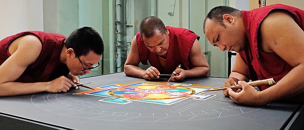 Mandala: Sacred art/Tibetan Buddhist monks from the Drepung Loseling Monastery in India create a sand mandala at the Virginia Museum of Fine Arts recently to share Tibet’s sacred visual and performing arts with area audiences. The monks’ work, created over four days, was completed in conjunction with the VMFA’s new exhibit, “Awaken: A Tibetan Buddhist Journey Toward Enlightenment,” that features roughly 100 historical and contemporary objects highlighting the role of art in Tibetan Buddhist culture and religious practices. (Sandra Sellars/Richmond Free Press)