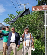 Cityscape- Slices of life and scenes in Richmond/A quartet joins in unveiling a tribute street sign Saturday to the late Percy J. Minor Sr. in honor of his commitment to revitalizing the city’s Swansboro neighborhood. From left, Mr. Minor’s widow, Mozelle Minor; 5th District City Councilman Parker Agelasto; and Mr. Minor’s sons, Percy Minor Jr. and Cecil Minor, remove the covering to reveal the honorary street sign at Bainbridge and 25th streets. Mr. Agelasto proposed the sign to pay tribute Mr. Minor, who advocated for Swansboro as president of the civic association. An ordinance passed by City Council credits Mr. Minor, who died in 2013, with pushing for development of more housing for retirees and other improvements. The ceremony was followed by a neighborhood cleanup led by Mr. Agelasto. (Sandra Sellars/Richmond Free Press)
