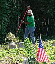 Celebrations of remembrance on Memorial Weekend/
Alan Delbridge, volunteer and outreach coordinator with Enrichmond Foundation, helps with cleanup efforts at the cemetery, the final resting place for many notable African-Americans including pioneering Richmond banker and businesswoman Maggie L. Walker. (Sandra Sellars/Richmond Free Press)