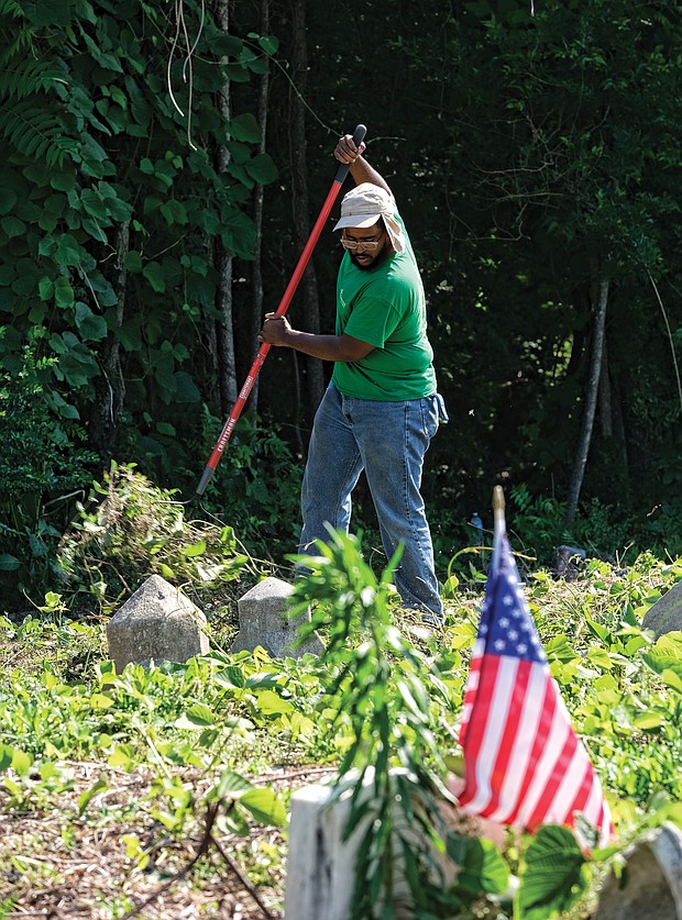 Celebrations of remembrance on Memorial Weekend/
Alan Delbridge, volunteer and outreach coordinator with Enrichmond Foundation, helps with cleanup efforts at the cemetery, the final resting place for many notable African-Americans including pioneering Richmond banker and businesswoman Maggie L. Walker. (Sandra Sellars/Richmond Free Press)