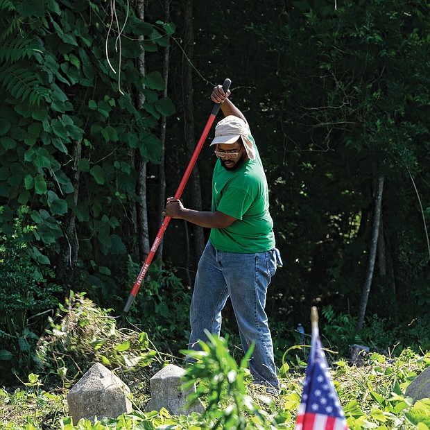 Celebrations of remembrance on Memorial Weekend/
Alan Delbridge, volunteer and outreach coordinator with Enrichmond Foundation, helps with cleanup efforts at the cemetery, the final resting place for many notable African-Americans including pioneering Richmond banker and businesswoman Maggie L. Walker. (Sandra Sellars/Richmond Free Press)