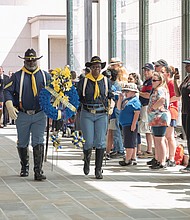 Celebrations of remembrance on Memorial Weekend/
Eddie Rose and Patricia Williams of the Mark Matthews Chapter of Petersburg, 9th and 10th Cavalry of the Buffalo Soldiers Association carry a wreath to be placed at the feet of the statue of Memory during Monday’s 63rd Annual Commonwealth’s Memorial Day Ceremony at the Virginia War Memorial on South Belvidere Street in Downtown. (Ava Reaves/Richmond Free Press)