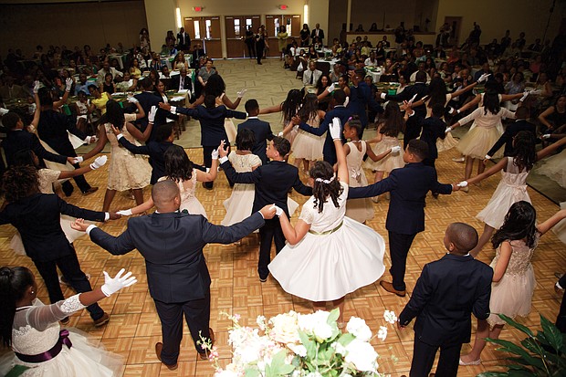 Enchanted by the dance
Forty-six middle school students from the Richmond and Tidewater areas enjoy the art of the dance at the 7th Annual Richmond Renaissance Junior Cotillion sponsored by the James River Virginia Chapter of Jack & Jill of America on May 18. Theme for the cotillion held at First Baptist Church Iron Bridge in Chesterfield County: “The Enchanted Garden.” In the five months leading up to the cotillion, the youths participated in a range of activities promoting civic responsibility, social consciousness, self-discovery and community engagement. In addition to learning formal dances, they completed community service projects, had lessons on etiquette, financial literacy, goal-setting, professional dress and branding and team-building skills. (Photo by Franklin Fitzgerald Photography)