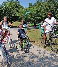 Celebrations of remembrance and fun on Memorial Weekend/
Memorial Day and the holiday weekend was a time for remembrance and fun for people throughout the Richmond area. Families and friends enjoyed outdoor activities during the weekend. Andre Quarles, right, rides his 2-year-old daughter, Aniya, through Byrd Park on Saturday, accompanied by other family members, from left, Ki’najma Quarles, 8; Alaura Oliver, 9; Ce’ondre Bland, 5; and Elijah Bland, 7. (Sandra Sellars/Richmond Free Press)