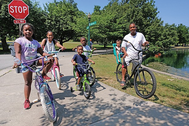 Celebrations of remembrance and fun on Memorial Weekend/
Memorial Day and the holiday weekend was a time for remembrance and fun for people throughout the Richmond area. Families and friends enjoyed outdoor activities during the weekend. Andre Quarles, right, rides his 2-year-old daughter, Aniya, through Byrd Park on Saturday, accompanied by other family members, from left, Ki’najma Quarles, 8; Alaura Oliver, 9; Ce’ondre Bland, 5; and Elijah Bland, 7. (Sandra Sellars/Richmond Free Press)