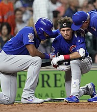 Chicago Cubs' Albert Almora Jr. is consoled after hitting a foul ball into the stands.