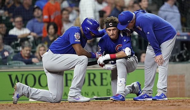 Chicago Cubs' Albert Almora Jr. is consoled after hitting a foul ball into the stands.