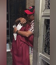 Sarai Ruiz embraces her father on a border bridge in her cap and gown, because her father couldn't attend her graduation.