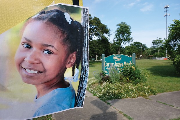 A flier bearing 9-year-old Markiya Dickson’s picture is posted near an entrance to Carter Jones Park at 28th and Perry streets in South Side. The Chesterfield County third-grader was shot and killed at the park on Sunday. An 11-year-old was wounded.