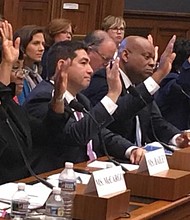 After hours of testimony before the House Finance Committee's Subcommittee on Housing, Community Development and Insurance, witnesses raise their hands in response to a question on whether homeownership discrimination against Blacks continues today. Seated left to right are: Alanna McCargo, vice president for Housing Finance Policy, Urban Institute; Nikitra Bailey, executive vice president, Center for Responsible Lending; Joseph Nery, president, National Association of Hispanic Real Estate Professionals; Jeff Hicks, president/CEO; National Association of Black Real Estate Brokers (NAREB); Carmen Castro, managing housing counselor, Housing Initiative Partnership; Joanne Poole, liaison for the National Association of Realtors; and Joel Griffith, research fellow, Financial Regulations, The Heritage Foundation. PHOTO: Hazel Trice Edney