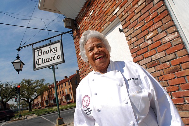 In this March 2007 photo, Leah Chase stands outside of her famous New Orleans restaurant, Dooky Chase’s, that was started by her husband’s family in the early 1940s.