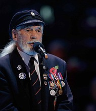 Veteran Jim Radford speaks at The Royal British Legion's Festival of Remembrance matinee performance in 2014 at Royal Albert Hall in London.