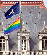 The flag was raised in conjunction with the opening of a Pride Month exhibit, "Equality Will Never Be Silent," which is set up in the Capitol building in Albany and will remain open through the summer.