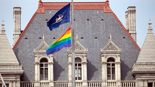 The flag was raised in conjunction with the opening of a Pride Month exhibit, "Equality Will Never Be Silent," which is set up in the Capitol building in Albany and will remain open through the summer.