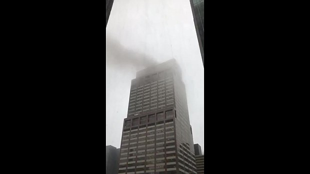 A helicopter made a hard landing on the roof of a building in Manhattan and a fire ensued, New York Gov. Andrew Cuomo said Monday. In this image, smoke appears to be rising out of the building in Manhattan where the helicopter crashed.