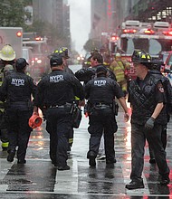 New York City police and firefighters arrive at the helicopter crash.