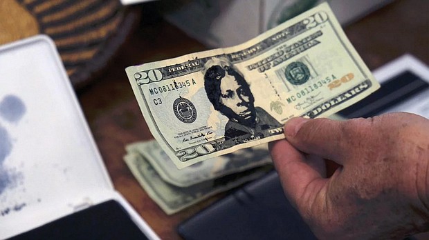 A U.S. $20 bill from the offering plate at Hope Central Church in Boston is stamped with the face of abolitionist Harriet Tubman on June 2.