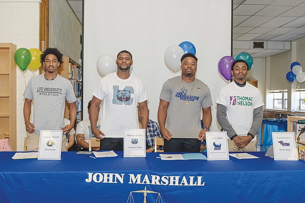 Four John Marshall basketball players reveal their college choices at a ceremony June 5 at the North Side high school. They are, from left, Aubrey Merritt, DeMarr McRae, Levar Allen and Tre Harris-McKenzie.