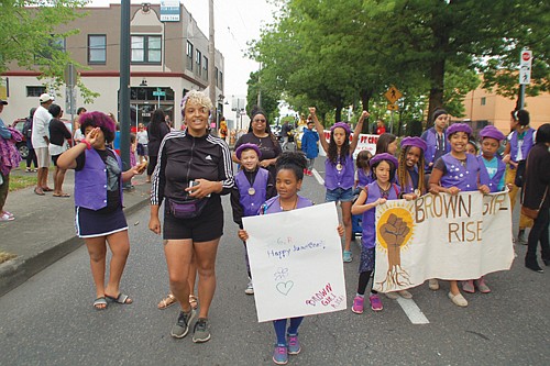 Members of the community group Brown Girl Rise participate in Saturday’s annual Juneteenth Parade on Northeast Martin Luther King Jr. Boulevard.