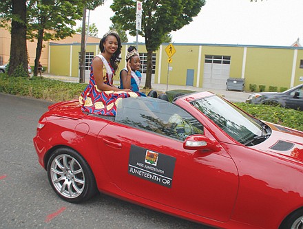 Miss Juneteenth Oregon 2019 Aceia Spade and Little Miss Juneteenth 2019 RinaTchivandja, age 12, ride atop an open convertible.