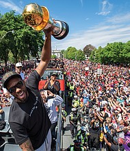 Kawhi Leonard leads the celebration as the Toronto Raptors parade through a sea of adoring fans Monday after upsetting the Golden State Warriors to secure their first NBA title.