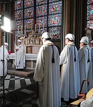 The Archbishop of Paris, Michel Aupetit, second from left, leads the first Mass in a side chapel on June 15, two months after a devastating fire engulfed the Notre Dame Cathedral in Paris.