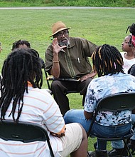 Celebrating Juneteenth/
Hundreds of people enjoy activities last Saturday at “Juneteenth: A Freedom Celebration” on the waterfront of the James River in South Side at the Manchester Dock. The three-day event, organized by the Elegba Folklore Society and its founder, Janine Y. Bell, marks the date on June 19, 1865, when enslaved people in Texas learned of their freedom after the defeat of the Confederates and Union forces took control of that state. Richmond’s celebration included educational sessions for people of all ages to learn about Africans brought to this nation 400 years ago and their struggles and contributions. At Saturday’s events, called “Independence Day Our Way,”  Dr. W. Neal Holmes, an adjunct political science professor at Virginia Union and Virginia State universities, offers lessons in a learning circle. Dr. Holmes facilitates a monthly study group at the Elegba Folklore Society, 101 E. Broad St. in Downtown. (Sandra Sellars/Richmond Free Press)