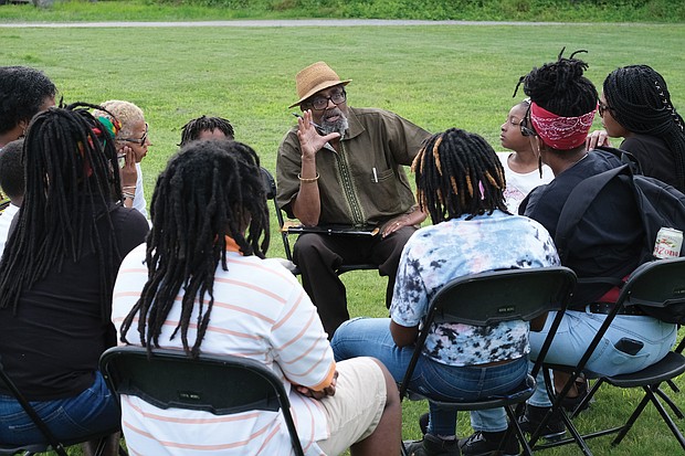 Celebrating Juneteenth/
Hundreds of people enjoy activities last Saturday at “Juneteenth: A Freedom Celebration” on the waterfront of the James River in South Side at the Manchester Dock. The three-day event, organized by the Elegba Folklore Society and its founder, Janine Y. Bell, marks the date on June 19, 1865, when enslaved people in Texas learned of their freedom after the defeat of the Confederates and Union forces took control of that state. Richmond’s celebration included educational sessions for people of all ages to learn about Africans brought to this nation 400 years ago and their struggles and contributions. At Saturday’s events, called “Independence Day Our Way,”  Dr. W. Neal Holmes, an adjunct political science professor at Virginia Union and Virginia State universities, offers lessons in a learning circle. Dr. Holmes facilitates a monthly study group at the Elegba Folklore Society, 101 E. Broad St. in Downtown. (Sandra Sellars/Richmond Free Press)